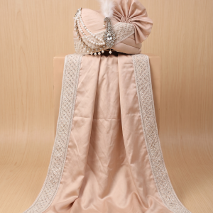 Beige raw silk groom pagri turban with peacock kalgi and matching pearl border stole display